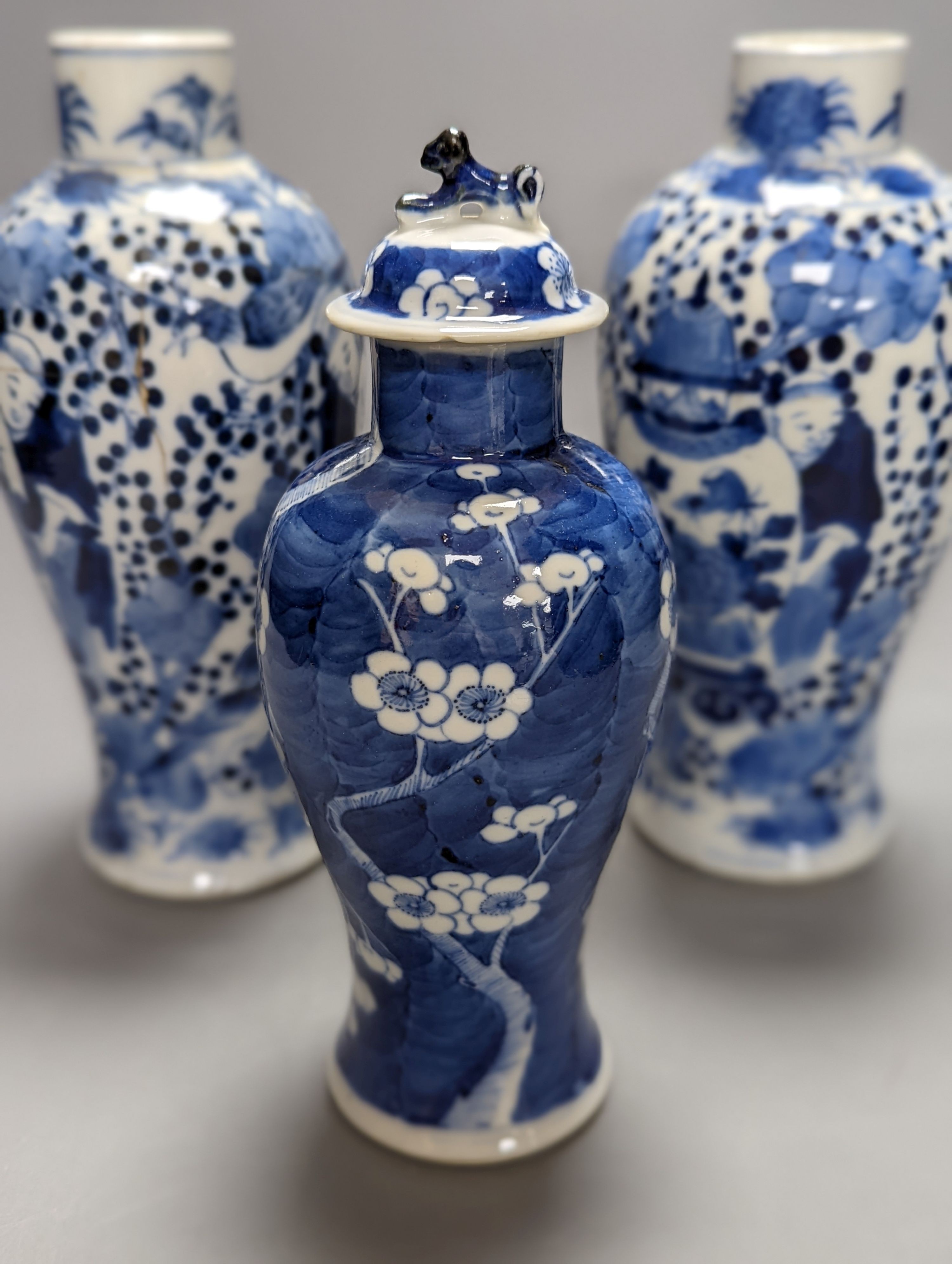 A pair of 19th century Chinese blue and white vases, a prunus vase and cover and a similar jar (4), pair of vases 24 cms high.